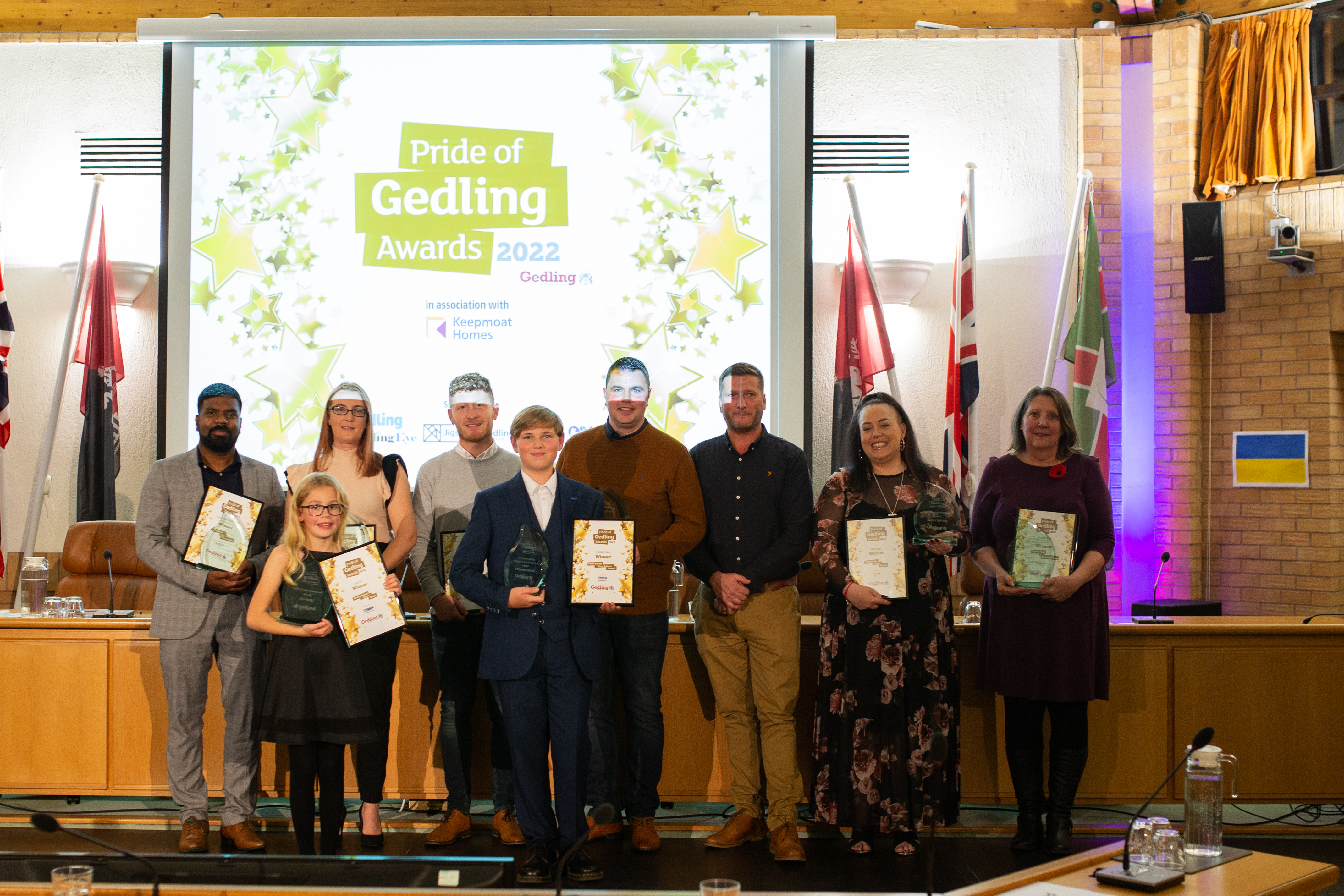 All the winners stood in front of the signage at the awards